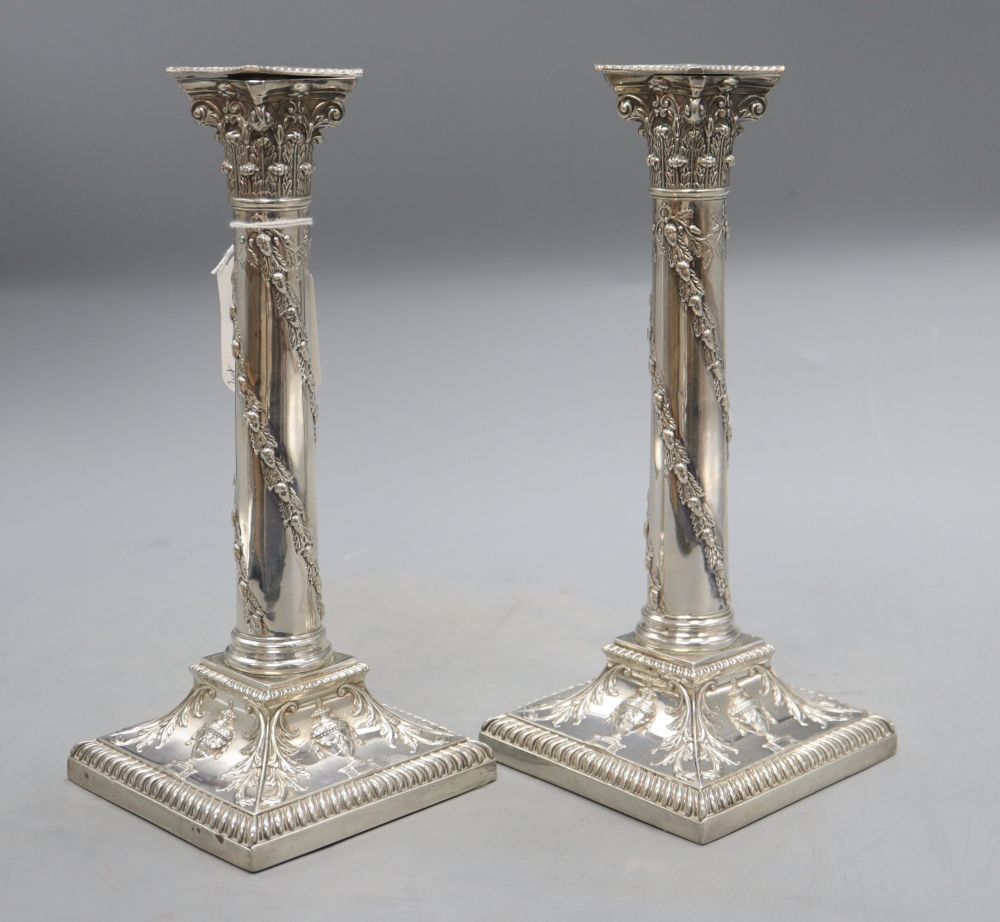 A pair of late Victorian silver candlesticks with acorn and urn decoration, Thomas Bradbury & Sons, London, 1898, 25cm, loaded,